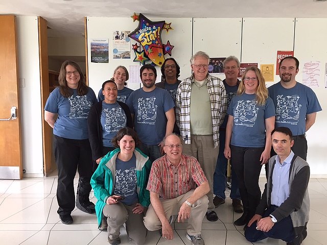 Group of twelve faculty members with a "You're a star" balloon in the background, celebrating the retirement of Bill Titus (at the center of the group). 