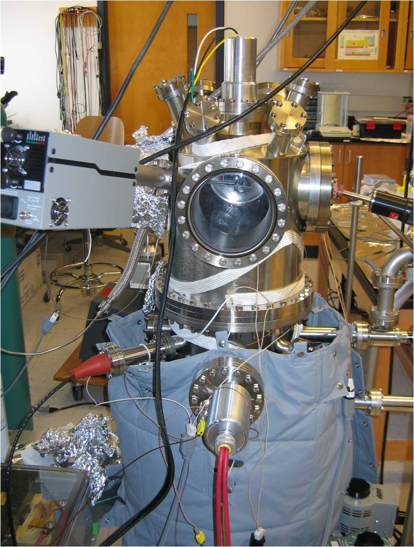 Photo an ultra-high vacuum chamber with many ports that have instrumentation such as a wobble stick and a residual gas analyzer connected to them.